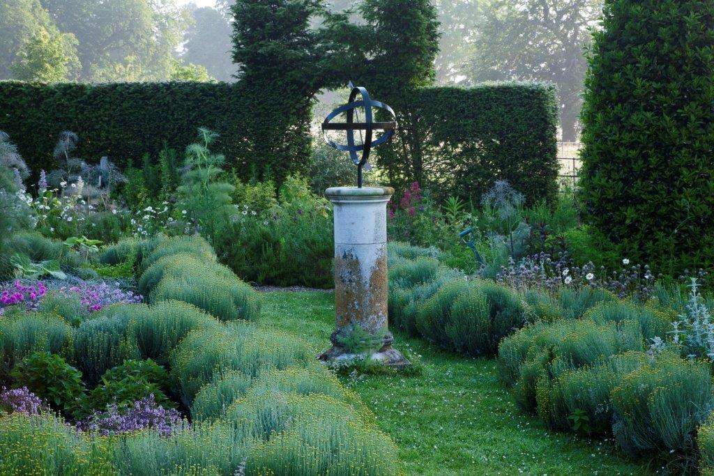 Herb garden with ornamental planting and garden features at Raveningham Gardens