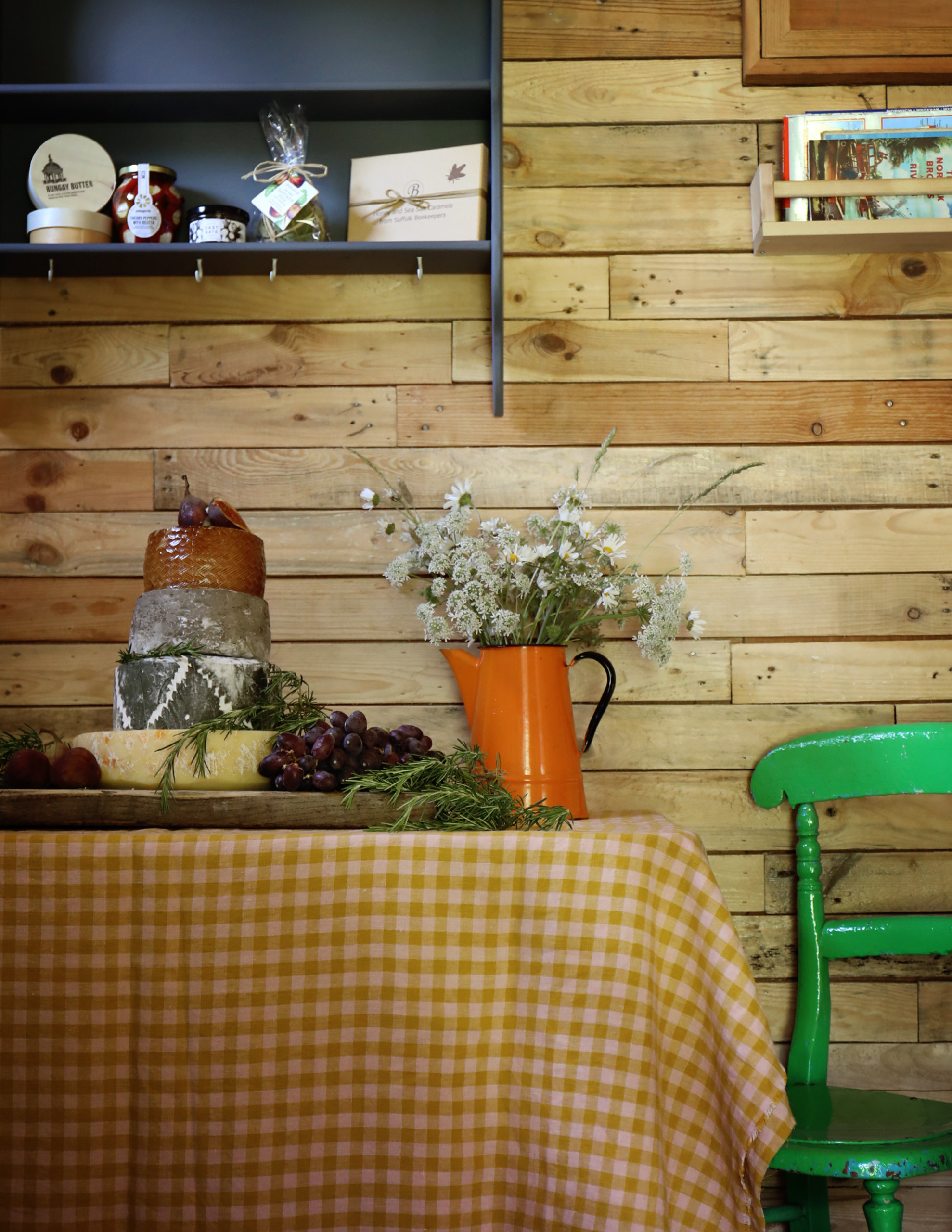 Rustic interior dining space with wooden walls and locally sourced produce.