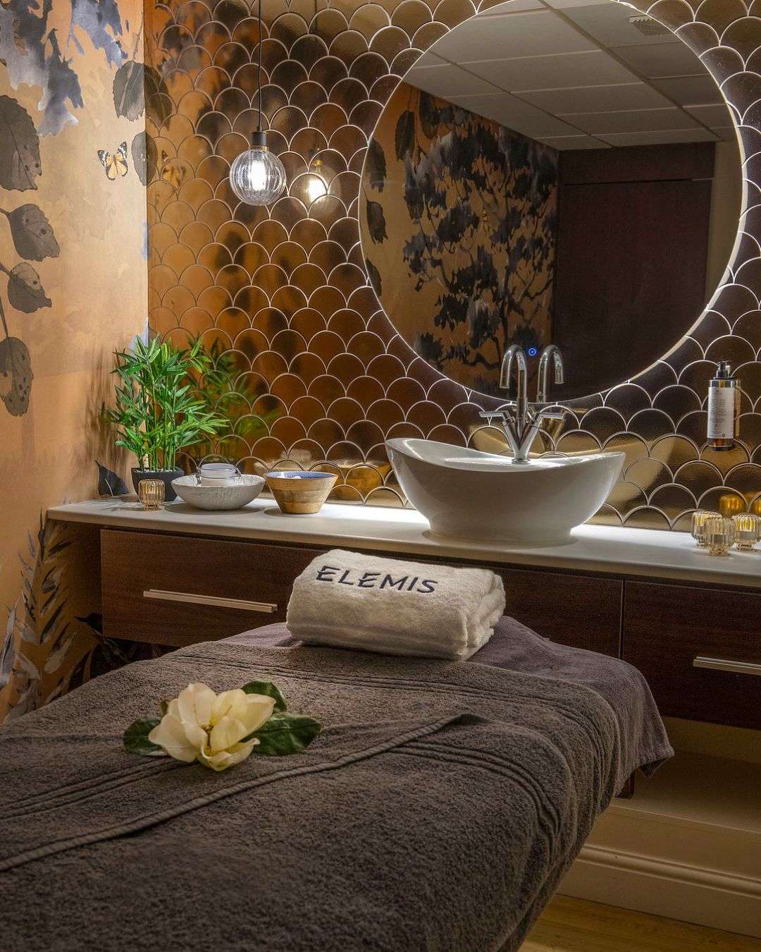 Luxury spa treatment room with feature basin, warm lighting and elegant décor at Dunston Hall.
