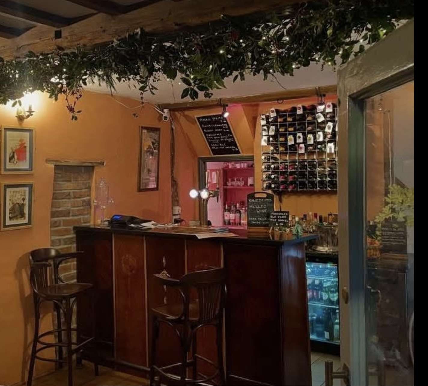 Elegant interior of Bar 44 in Aylsham, featuring a well-stocked bar, ambient lighting and welcoming dining space.