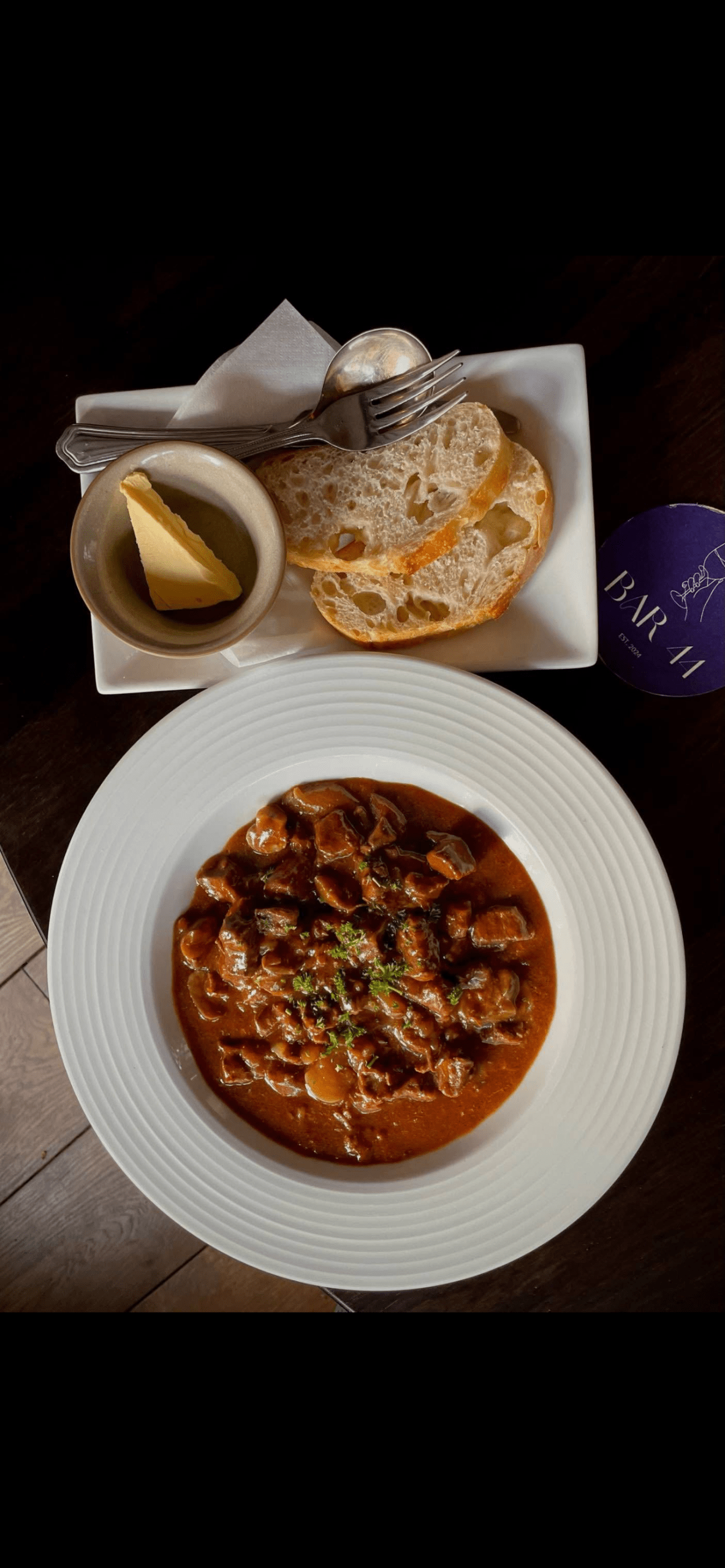 Freshly prepared meal served at Bar 44, accompanied by crusty bread and butter, showcasing the restaurant’s dining menu.