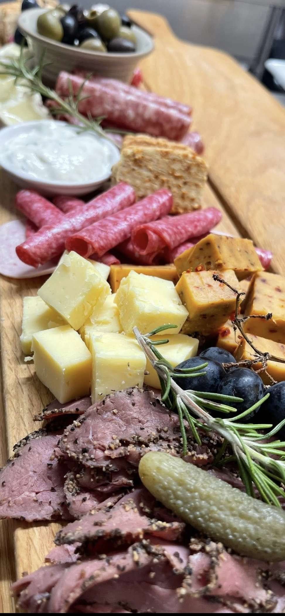 Selection of artisan cheeses served with grapes, crackers and accompaniments at Bar 44 in Aylsham.