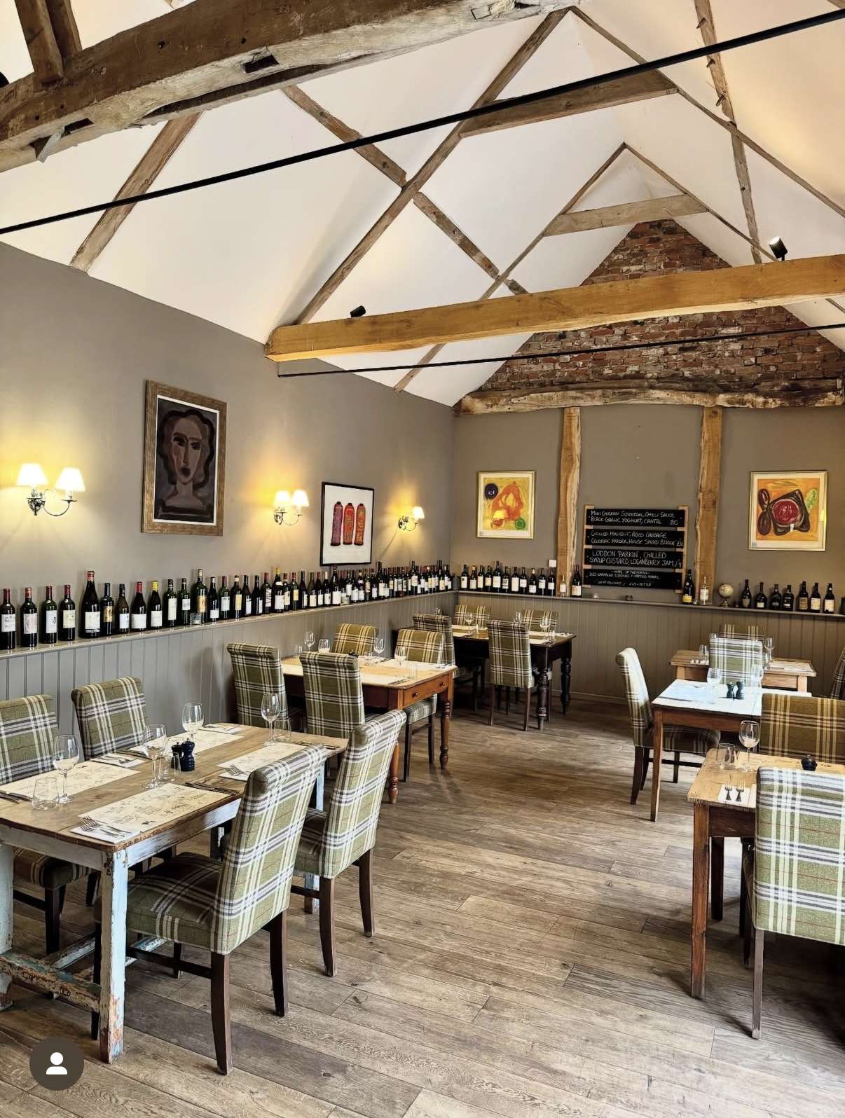 Stylish restaurant dining area with exposed beams, neatly laid tables and contemporary décor at the Swan Hotel Loddon