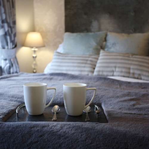 Comfortable guest bedroom at The Recruiting Sergeant, featuring a well-appointed bed, soft furnishings and a relaxing boutique atmosphere.