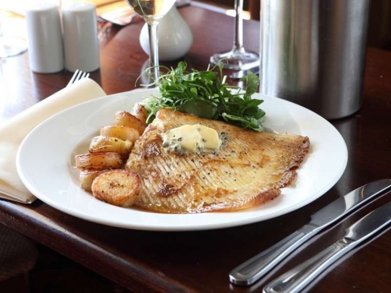 Pan-fried fish fillet served at The Recruiting Sergeant with roasted potatoes, seasonal vegetables and a creamy sauce.
