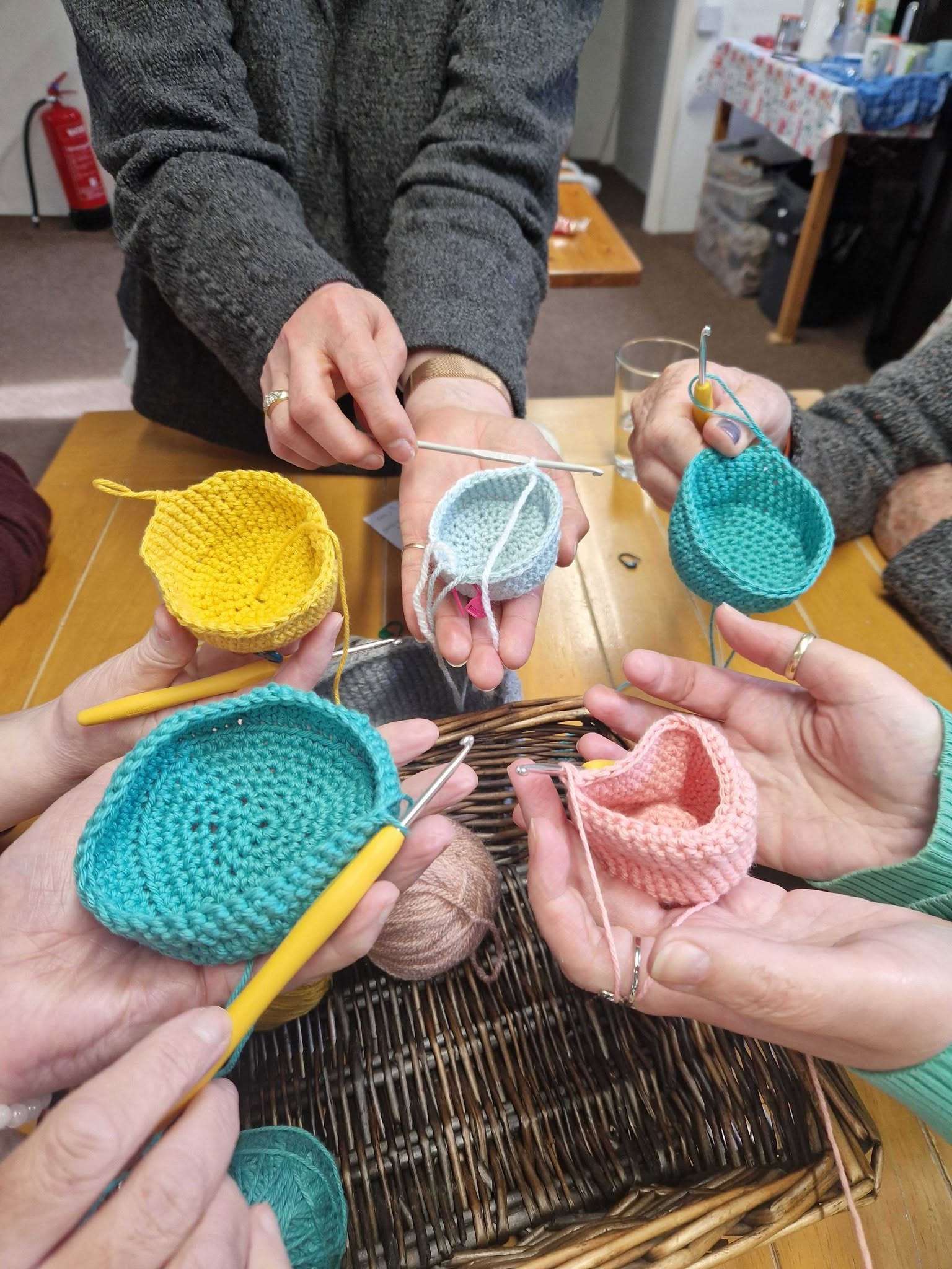 Participants crocheting colourful handmade items during a craft workshop at Albright of Diss.
