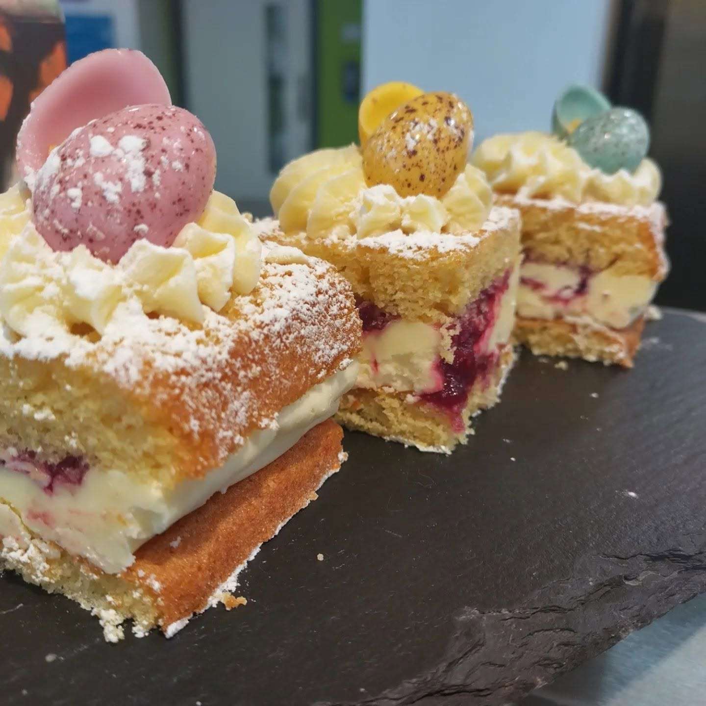 Assorted homemade cakes and traybakes displayed on a serving counter at Coffee with Flo