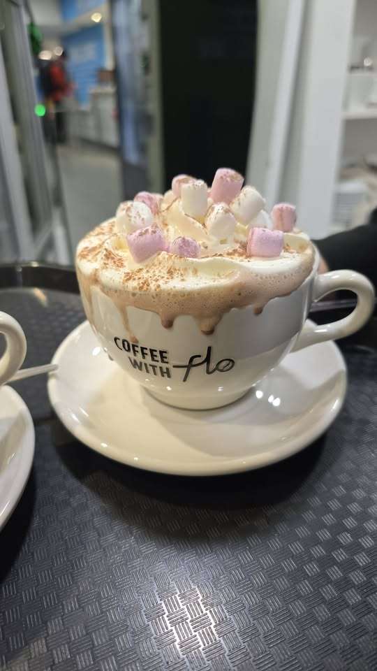 Luxury hot chocolate topped with marshmallows and cream served at Coffee with Flow