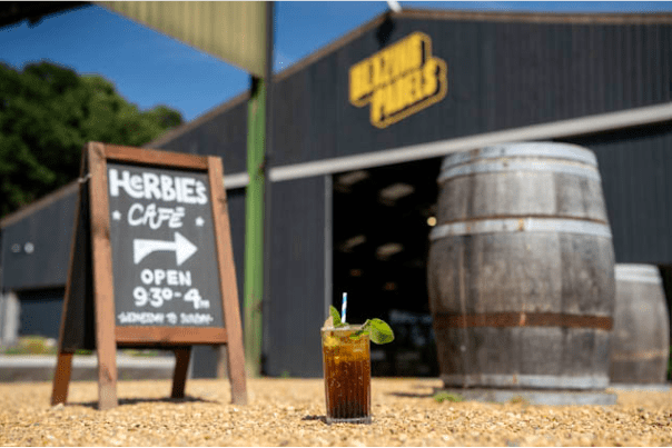 Entrance to Herbie's Farm Café at Salle Moor Farm, with café signage outside the Black Barns building in a rural Norfolk setting.
