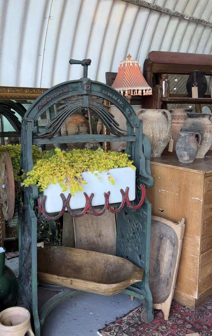 Vintage water feature and garden antiques displayed outside a Norfolk antiques centre.