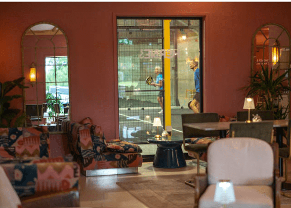Warm and welcoming interior of Herbie's Farm Café in Salle Moor, featuring comfortable seating and large windows overlooking the café space.
