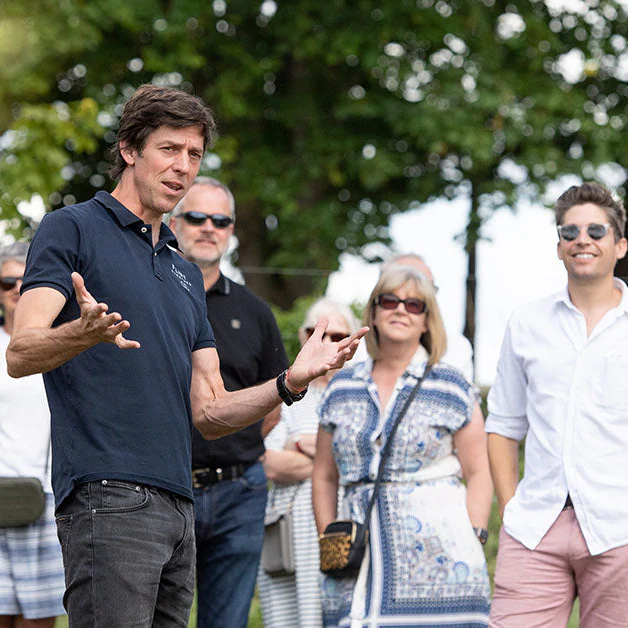 Guide leading a group on a tour of Flint vineyard