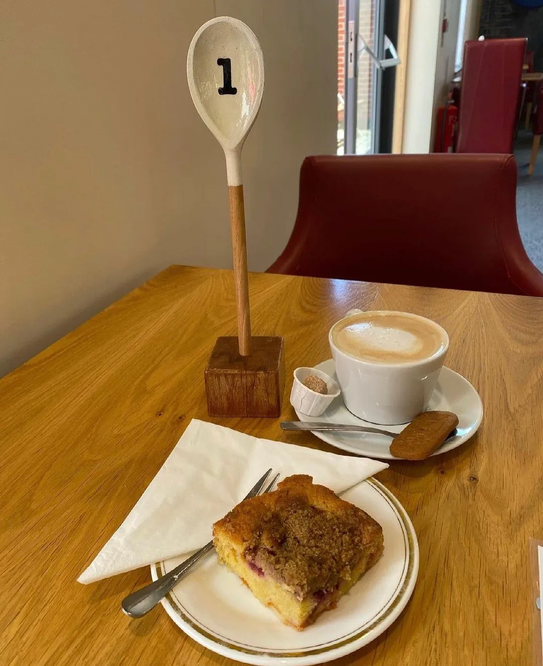 Cup of freshly brewed coffee served on a table inside Hug a Mug Café, showing the café's welcoming atmosphere.